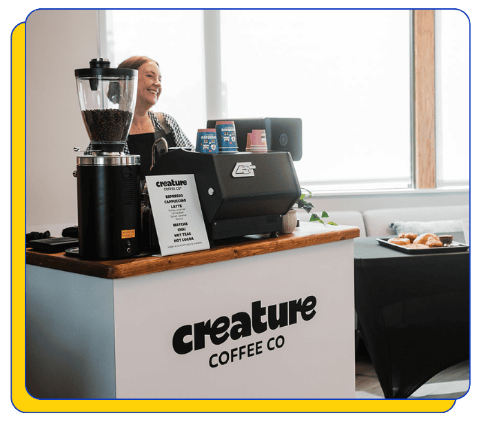 Mobile Coffee shop with 'creature Coffee Co' branding, featuring a Mahlkonig coffee grinder and La Marzocco espresso machine.
