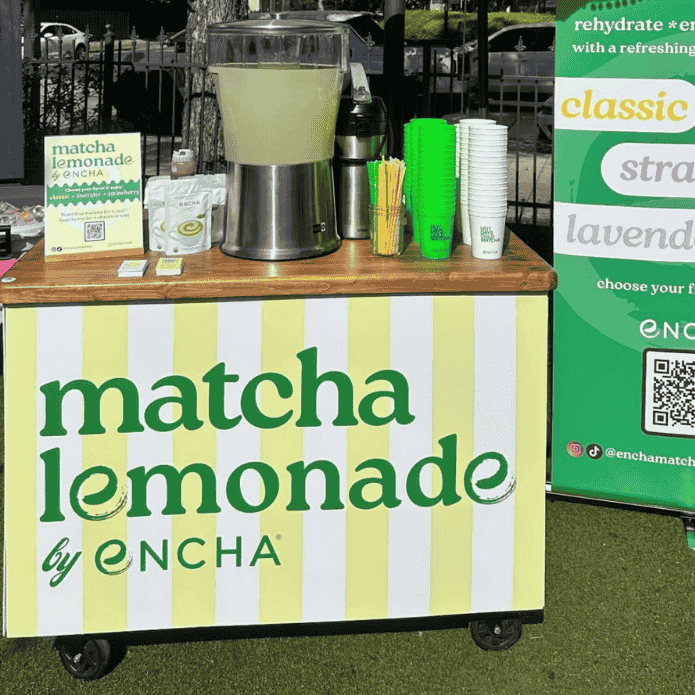 Matcha lemonade stand with ENCHA branding and promotional materials.
