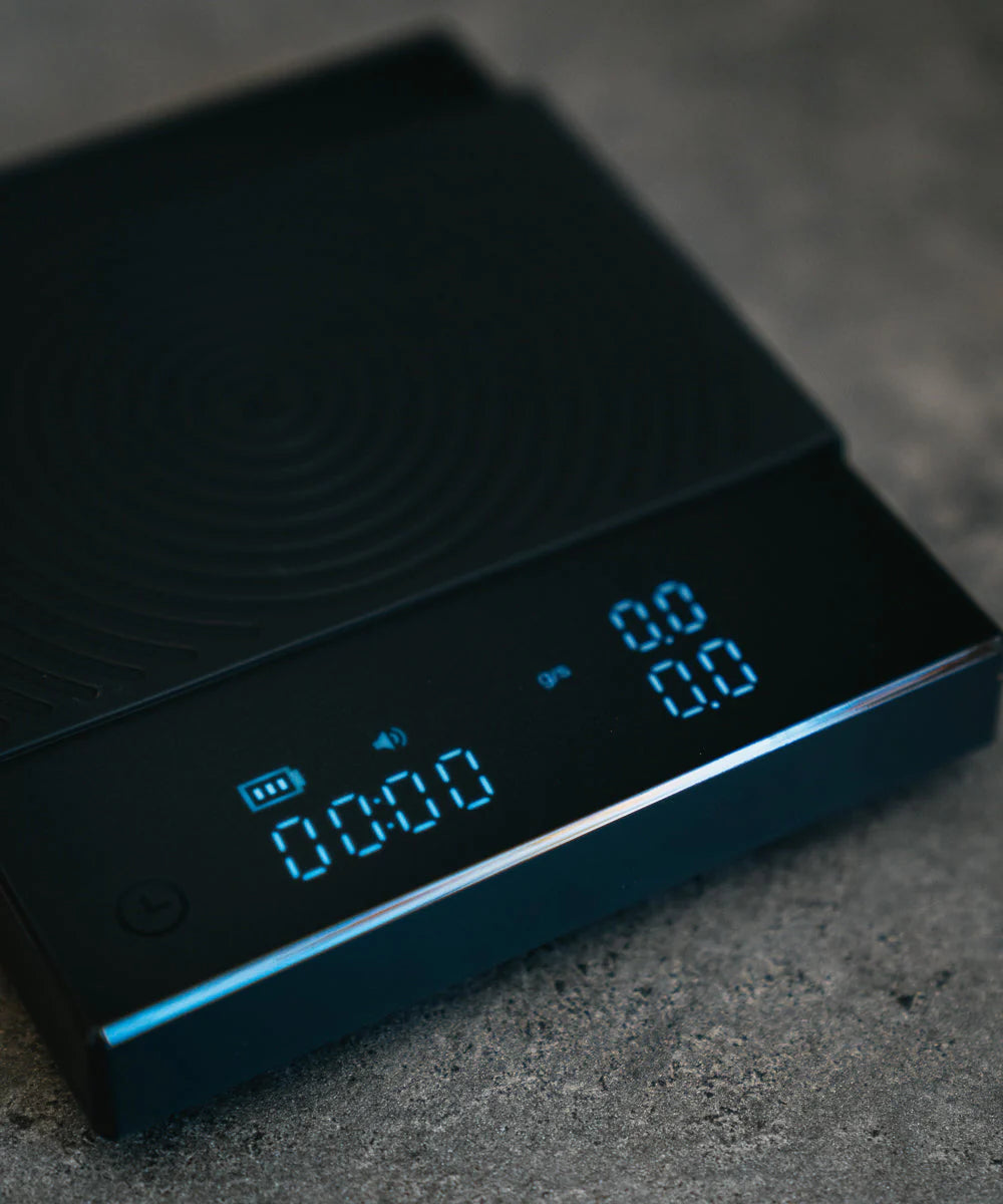 Timemore Black Mirror Basic 2 digital coffee scale used for precise pour over, espresso, and drip coffee brewing at home. Close up shot of scale. 